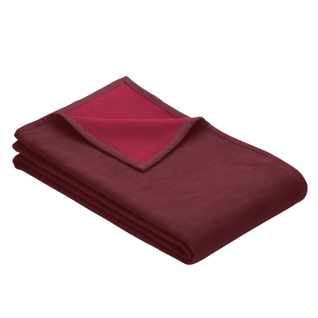 Cranberry red blanket folded showing 2 shades of red