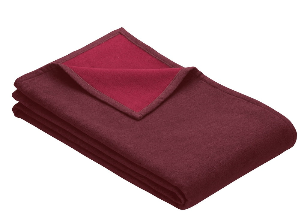Cranberry red blanket folded showing 2 shades of red