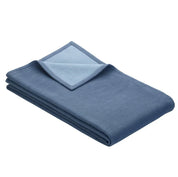 Folded blanket in blue and light blue on reverse side